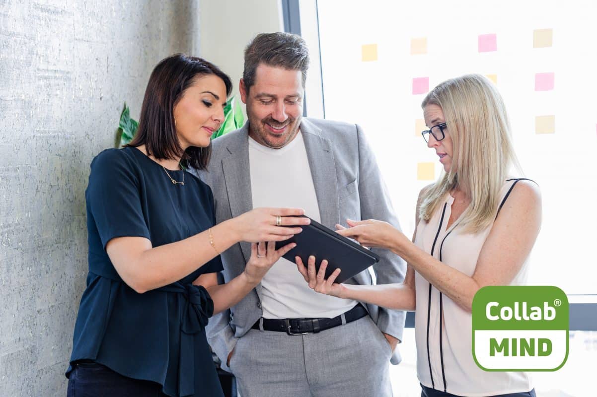 Three people looking at kyona digital collaboration suite on an tablet